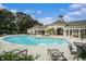 Relaxing community pool with lounge chairs and clubhouse for the ultimate outdoor living experience at 1300 Park West Blvd # 420, Mount Pleasant, SC 29466