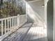 Covered porch featuring white railings and wood flooring, perfect for outdoor relaxation at 1300 Park West Blvd # 420, Mount Pleasant, SC 29466