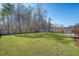 Expansive backyard with green lawn, wooden fence, and patio seating area at 1305 Discovery Dr, Ladson, SC 29456