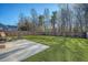 Large, lush backyard with a well-maintained lawn, wooden fence, and patio at 1305 Discovery Dr, Ladson, SC 29456