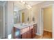 Bright bathroom featuring a double vanity with a granite countertop and framed mirror at 1305 Discovery Dr, Ladson, SC 29456