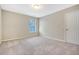 Bright carpeted bedroom with neutral colors and a window overlooking the neighborhood at 1305 Discovery Dr, Ladson, SC 29456