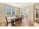 Dining room with wood table and chairs, flooded with natural light from large window at 1305 Discovery Dr, Ladson, SC 29456