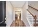 Inviting entryway features hardwood floors, staircase, and view into the living room at 1305 Discovery Dr, Ladson, SC 29456