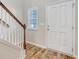Charming foyer with hardwood floors, white door, and natural light from nearby window at 1305 Discovery Dr, Ladson, SC 29456