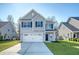 Charming two-story home featuring a two-car garage, well-maintained lawn, and attractive gray siding at 1305 Discovery Dr, Ladson, SC 29456