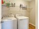 Convenient laundry room with full-size washer and dryer and overhead shelf at 1305 Discovery Dr, Ladson, SC 29456