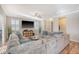 Large and inviting living room with hardwood flooring, a comfy sectional, and a big-screen TV at 1305 Discovery Dr, Ladson, SC 29456