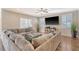 Spacious living room featuring hardwood floors, a large sectional sofa, and plenty of natural light at 1305 Discovery Dr, Ladson, SC 29456