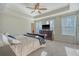 Serene main bedroom featuring a tray ceiling, plush carpeting, and plenty of natural light at 1305 Discovery Dr, Ladson, SC 29456