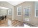 Sunroom overlooking the dining room and back patio with hardwood floors and three windows at 1305 Discovery Dr, Ladson, SC 29456