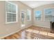 Sunroom with three windows and a door, and hardwood floors at 1305 Discovery Dr, Ladson, SC 29456