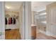 View of a walk-in closet leading to a light and bright bathroom with glass enclosed shower at 1305 Discovery Dr, Ladson, SC 29456