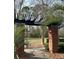 Entrance sign under pergola near paved pathway with palm trees and foliage at 1310 Basildon Rd # 1310, Mount Pleasant, SC 29466