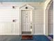 Charming white front door with decorative accents and welcoming 'hello' mat at 1310 Basildon Rd # 1310, Mount Pleasant, SC 29466