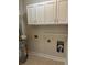 Bright laundry room features white cabinets, tile flooring, and convenient shelving at 1310 Basildon Rd # 1310, Mount Pleasant, SC 29466