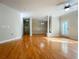 Open-concept living area with hardwood flooring, columns, and a ceiling fan at 1310 Basildon Rd # 1310, Mount Pleasant, SC 29466