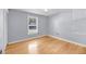 This bedroom features gray walls, wood floors, a ceiling fan, and a window at 1402 Camp Rd # 8B, Charleston, SC 29412