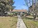Community clubhouse featuring tropical landscaping and inviting entrance at 1402 Camp Rd # 8B, Charleston, SC 29412