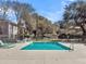 Community pool surrounded by lounge chairs and mature trees at 1402 Camp Rd # 8B, Charleston, SC 29412