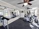 A community gym with mirrors, rubber floors, ceiling fans, and exercise equipment at 1402 Camp Rd # 8B, Charleston, SC 29412