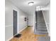 Hallway with hardwood floors leads to staircase at 1402 Camp Rd # 8B, Charleston, SC 29412
