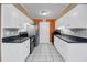 Traditional kitchen with white cabinetry, stainless steel appliances, and an orange accent wall at 1402 Camp Rd # 8B, Charleston, SC 29412
