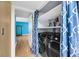 This laundry room features a black washer and dryer set behind blue curtains at 1402 Camp Rd # 8B, Charleston, SC 29412