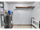 The utility room features beige floors, white walls, a hot water heater, and shelving at 1402 Camp Rd # 8B, Charleston, SC 29412