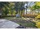 Spacious backyard featuring a storage shed, mature trees, and a designated fire pit area for entertaining at 1589 Kentwood Cir, Charleston, SC 29412