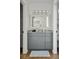 Bathroom with a gray vanity, decorative mirror, and a four-light fixture offering both style and function at 1589 Kentwood Cir, Charleston, SC 29412