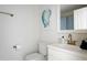 Clean bathroom with a white vanity, gold fixtures, and a framed painting at 1589 Kentwood Cir, Charleston, SC 29412