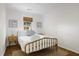 Cozy bedroom with a brass bed frame, wood nightstands, and ample natural light at 1589 Kentwood Cir, Charleston, SC 29412