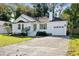 Inviting single-story home with a paved driveway, attached garage, and a well-manicured front yard at 1589 Kentwood Cir, Charleston, SC 29412