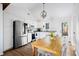 Sunlit kitchen with stainless steel appliances, white cabinets, dining table, and hardwood floors at 1589 Kentwood Cir, Charleston, SC 29412