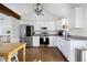 Bright kitchen featuring stainless steel appliances, white cabinetry, granite countertops, and hardwood floors at 1589 Kentwood Cir, Charleston, SC 29412