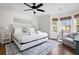 Bright main bedroom with a ceiling fan, a plush rug, and a cozy seating area with views of the outdoors at 1589 Kentwood Cir, Charleston, SC 29412