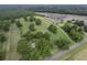 Wide aerial perspective of a land, featuring mature trees, agricultural fields, and a country road at 1758 Mendel Rivers Rd, Saint Stephen, SC 29479