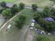 Aerial view of farmland and homestead, with mature trees, and multiple outbuildings at 1758 Mendel Rivers Rd, Saint Stephen, SC 29479