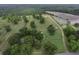 Expansive aerial view of land showcasing agricultural fields, mature trees, and a house at 1758 Mendel Rivers Rd, Saint Stephen, SC 29479
