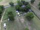 Expansive property featuring open fields, mature trees, outbuildings, and gardens, with a glimpse of the home and a pool at 1758 Mendel Rivers Rd, Saint Stephen, SC 29479
