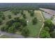A pond is the focus of this aerial view, with a treed landscape and farmland visible at 1758 Mendel Rivers Rd, Saint Stephen, SC 29479