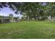Large, grassy backyard featuring an above-ground pool, mature trees, and a storage shed at 1758 Mendel Rivers Rd, Saint Stephen, SC 29479