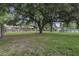 Expansive backyard featuring a classic brick home, bordered by a fence, with mature trees and well-kept lawn at 1758 Mendel Rivers Rd, Saint Stephen, SC 29479