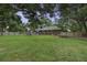 Lush backyard with a well-maintained lawn, bordered by a wooden fence and mature trees, offering privacy at 1758 Mendel Rivers Rd, Saint Stephen, SC 29479
