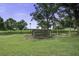 Backyard with a wooden pergola, offering potential for a garden or relaxation area at 1758 Mendel Rivers Rd, Saint Stephen, SC 29479