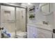 Bathroom features a white vanity, framed sliding glass door shower, and charming dinosaur decor at 1758 Mendel Rivers Rd, Saint Stephen, SC 29479