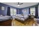 Cozy bedroom features hardwood floors, ceiling fan, and playful dinosaur-themed decorations at 1758 Mendel Rivers Rd, Saint Stephen, SC 29479