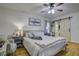 Comfortable bedroom featuring hardwood floors, soft lighting, and a sliding barn door to ensuite at 1758 Mendel Rivers Rd, Saint Stephen, SC 29479