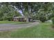 Brick home featuring mature trees, long driveway and covered carport at 1758 Mendel Rivers Rd, Saint Stephen, SC 29479